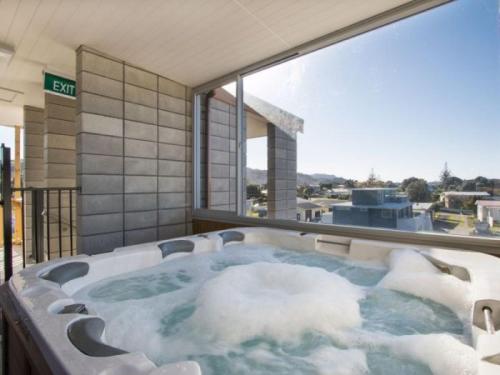 a hot tub with snow inside of a building at Beach Pacific Apartments in Waihi Beach