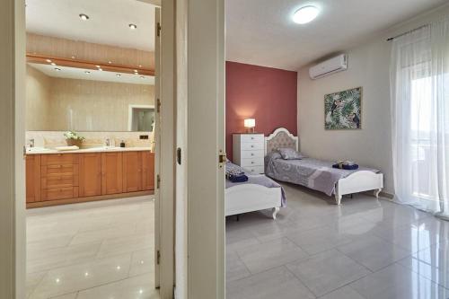 a bedroom with a bed and a bathroom at Villa Soledad en Olivella, Sitges, Barcelona in Olivella
