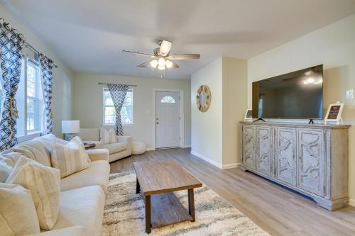 a living room with a couch and a tv at Gulfport Home with Fire Pit RVandTrailer Parking in Gulfport