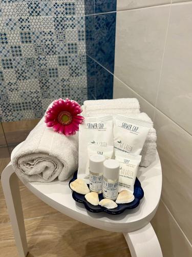 a white table with towels and a flower on it at Brezza Marina Guest House in Maiori