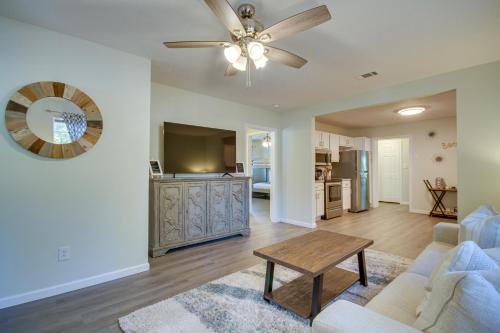 a living room with a couch and a ceiling fan at Gulfport Home with Fire Pit RVandTrailer Parking in Gulfport