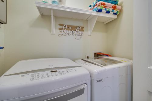 a small laundry room with a washer and dryer at Gulfport Home with Fire Pit RVandTrailer Parking in Gulfport