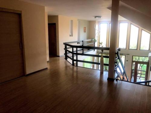 an empty room with a wooden floor and stairs at Pink House Advance Notice Required in Giarmata