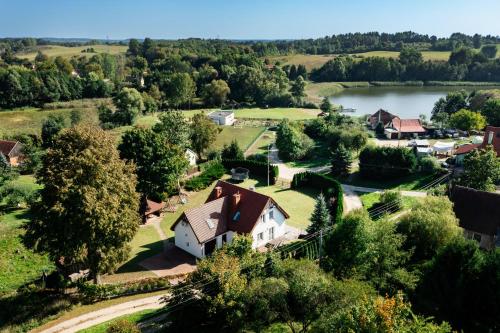 an aerial view of a house and a lake at Chill Warmia in Dywity
