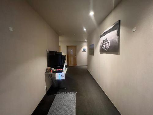 a room with a hallway with a tv on a wall at Hótel Skógafoss by EJ Hotels in Skogar