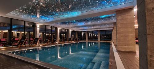 a swimming pool in a building with stars on the ceiling at Milmari Lux Apartment N74 Kopaonik in Kopaonik