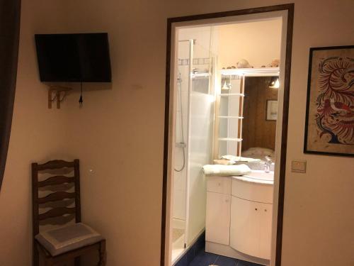 W łazience znajduje się umywalka i lustro. w obiekcie Chambre d’hôtes w mieście Les Chapelles