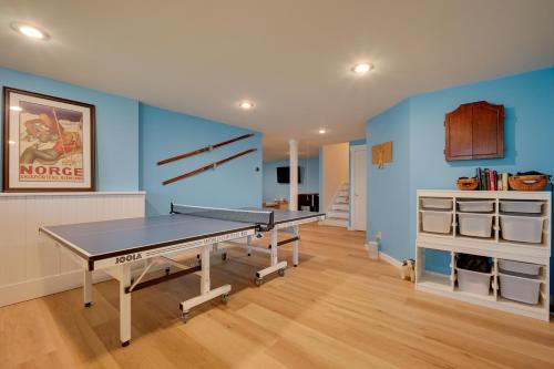 a ping pong table in a room with blue walls at West Dover Family Home with Game Room and Home Theater in West Dover