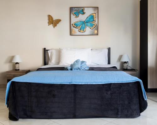 a bedroom with a bed with butterflies on the wall at Evzoi in Chalkida