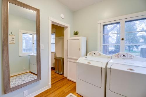 a laundry room with two washers and a mirror at Pet-Friendly Cottage 8 Mi to Paul Bunyan Land! in Brainerd