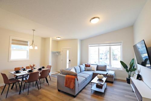 a living room with a couch and a table at Downtown 5 Bedroom, AC, Rogers, Commonwealth, EXPO in Edmonton