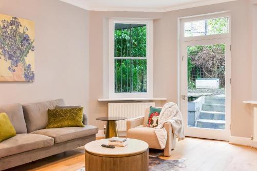 a living room with a couch and a table at Primrose Hill Park in London
