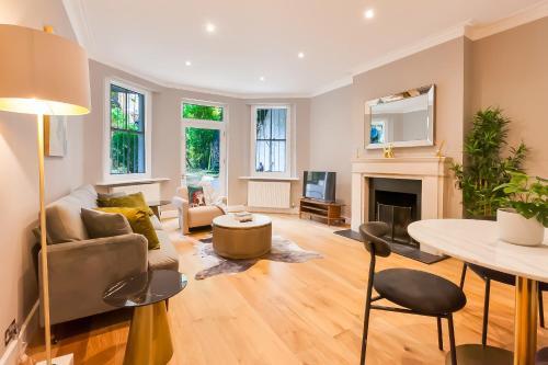 a living room with a couch and a table at Primrose Hill Park in London