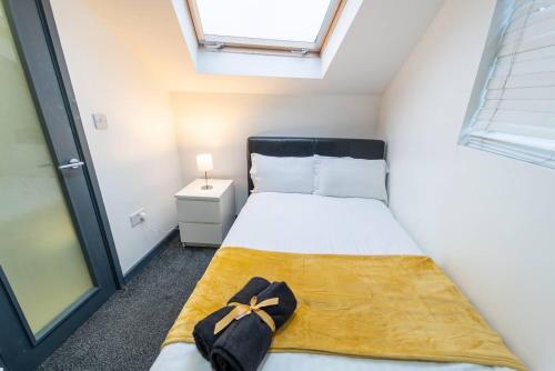 a small bedroom with a bed with a bow on it at Charming 1-Bed Studio in Birmingham in Birmingham
