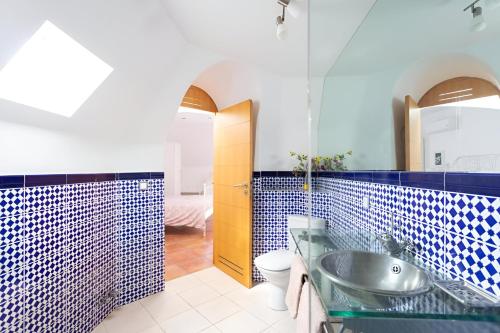a bathroom with a sink and a toilet and a mirror at EDEN RENTALS Duplex Adeje Palace in Playa Paraiso
