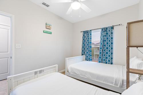 a bedroom with two beds and a window at Las Joyas Bayview Home in Port Isabel