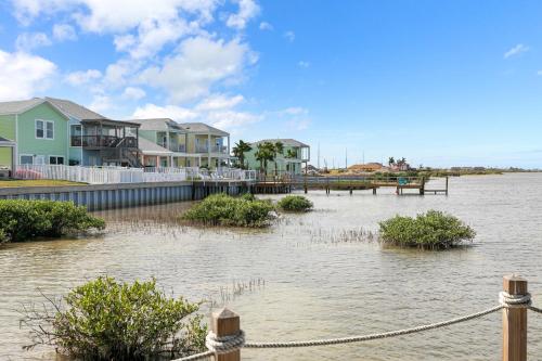 a body of water with houses and a dock at Las Joyas Bayview Home in Port Isabel