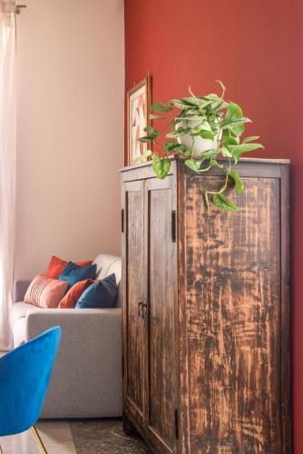 a wooden cabinet with a potted plant on top at Casa Matta in Castel Gandolfo