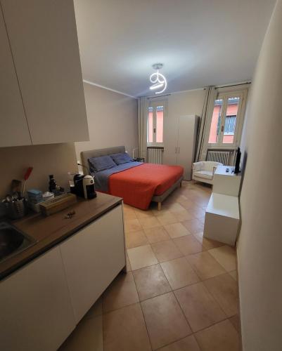 una cocina y un dormitorio con una cama en una habitación en La Rosa Cesena, en Cesena