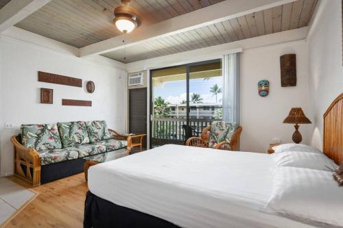 a bedroom with a bed and a living room at Kona Bali Kai Unit 362 Partial Ocean View Studio in Kailua-Kona