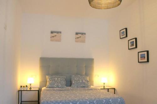 a bedroom with a bed and two tables with lamps at Casa de la Paz / Andalucia in Hozanejos