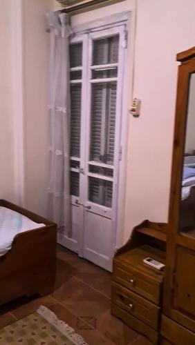 a bedroom with a white door and a dresser at الشاطبي in Alexandria