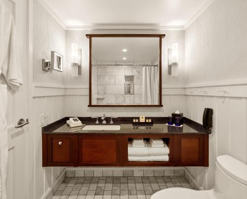 a bathroom with a sink and a mirror at The Charles Hotel in Harvard Square in Cambridge
