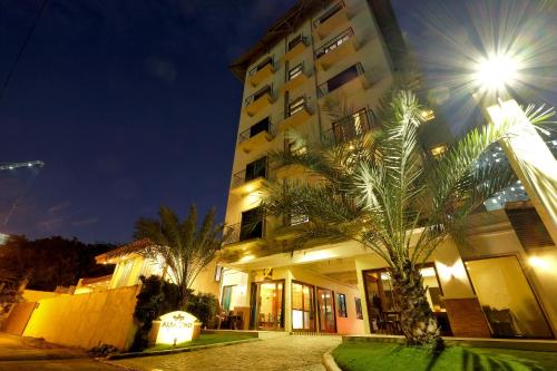 un bâtiment avec un palmier en face dans l'établissement Alba Uno Hotel, à Cebu