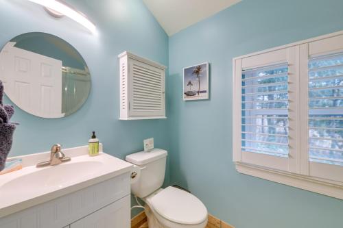 a bathroom with a toilet and a sink and a mirror at Waterfront Topping Vacation Home with Boat Dock! in Topping