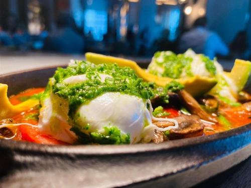 a bowl of food with broccoli and other vegetables at JW Marriott Hotel Monterrey Valle in Monterrey