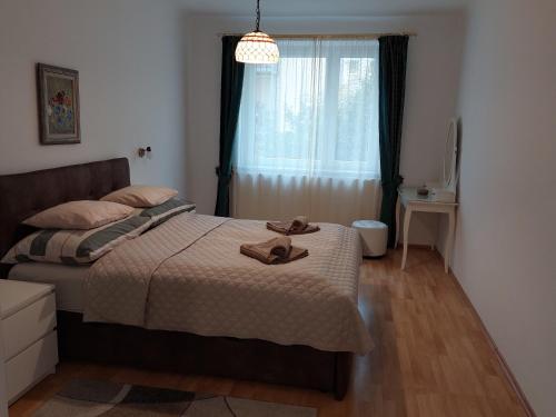 a bedroom with a bed with a pair of shoes on it at 3-rooms apartment for up to 4 persons near to Prater in Vienna