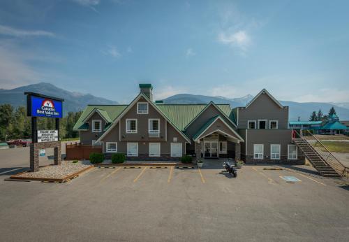 a large building with a sign in a parking lot at Canadas Best Value Inn Valemount in Valemount
