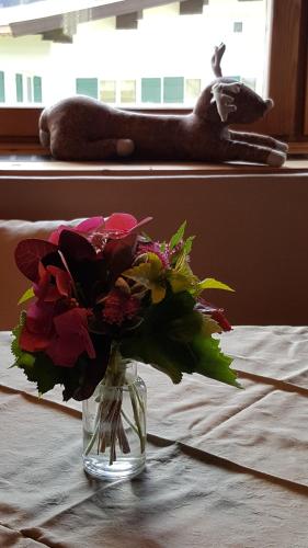 a vase filled with flowers sitting on a table at Appartement Seebacher in Hochfilzen