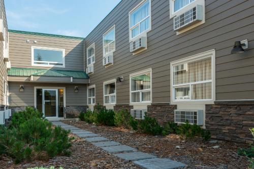 a house with a pathway in front of it at Canadas Best Value Inn Valemount in Valemount
