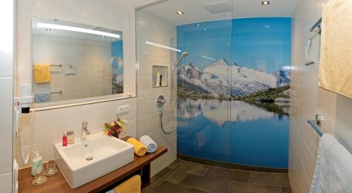 a bathroom with a sink and a shower at Schöne Aussicht Apartments in Tux