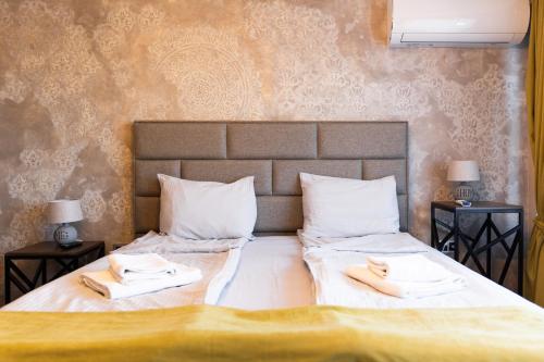 a bedroom with a bed with two towels on it at Dervent Apartment in Veliko Tŭrnovo