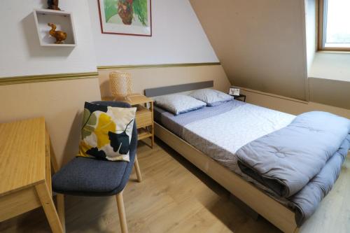 1 dormitorio pequeño con 1 cama y 1 silla en Nov Sweety Home en Goussainville