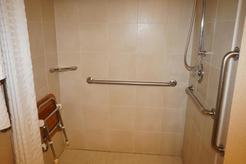a shower stall in a bathroom with a toilet at Wingate by Wyndham Bellingham Heritage Inn in Bellingham