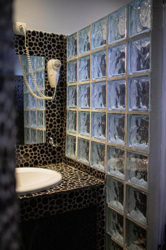 a bathroom with a toilet and glass block walls at Villa Eridos in Káto Lekhónia
