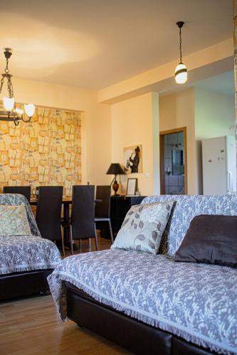 a bedroom with two beds and a stone wall at Villa Eridos in Káto Lekhónia