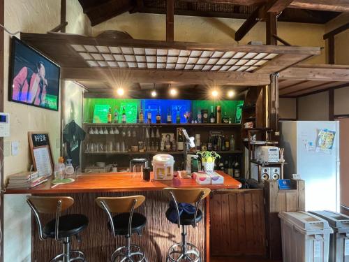 a bar in a restaurant with stools at Guest house HEART - Vacation STAY 98734v in Hitoyoshi