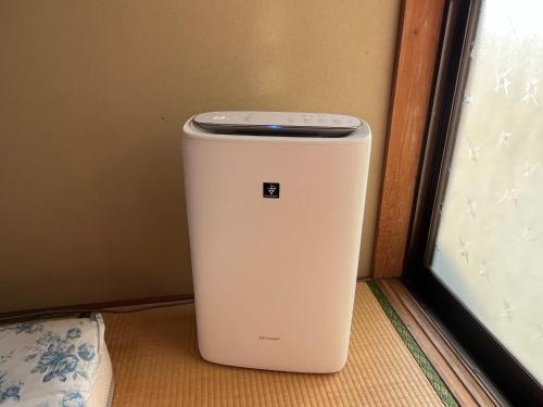 a white trash can sitting next to a window at Guest house HEART - Vacation STAY 98762v in Hitoyoshi