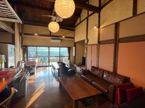 a living room with a couch and a table at Guest house HEART - Vacation STAY 04737v in Hitoyoshi