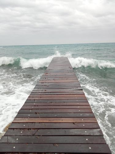 a wooden pier in the middle of the ocean at Voilier tout confort in Beaulieu-sur-Mer