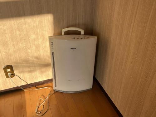 a small refrigerator in a corner of a room at Guest house HEART - Vacation STAY 04732v in Hitoyoshi