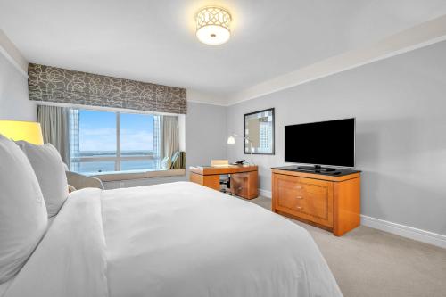 a bedroom with a bed and a flat screen tv at 2 Bedroom OR King Studio Suites Four Seasons Hotel Miami Free Wi-Fi & Free Parking in Miami