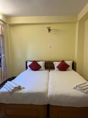 two beds sitting next to each other in a bedroom at Golden Gate Guest House in Bhaktapur
