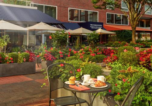 a table with a plate of food on it with flowers at The Charles Hotel in Harvard Square in Cambridge