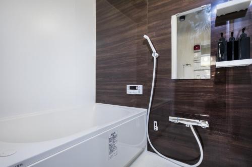 a bathroom with a shower with a white toilet at Shiki Homes | RURI - Vacation STAY 12774 in Osaka