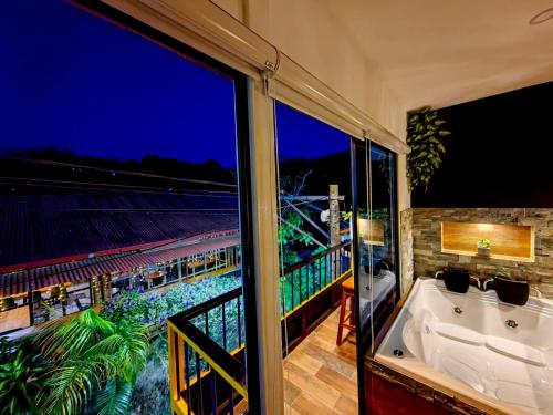 a bathroom with a tub and a view of a stadium at Habitación Deluxe 1 con Jacuzzi a 20mt del parque in Salento